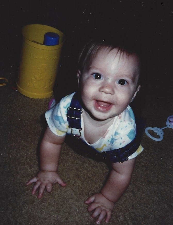 Erin Baby Picture baby smiling at the camera while crawling on hands and knees